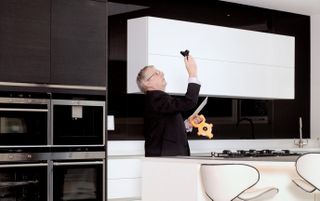 a surveyor conducting a building survey in a kitchen