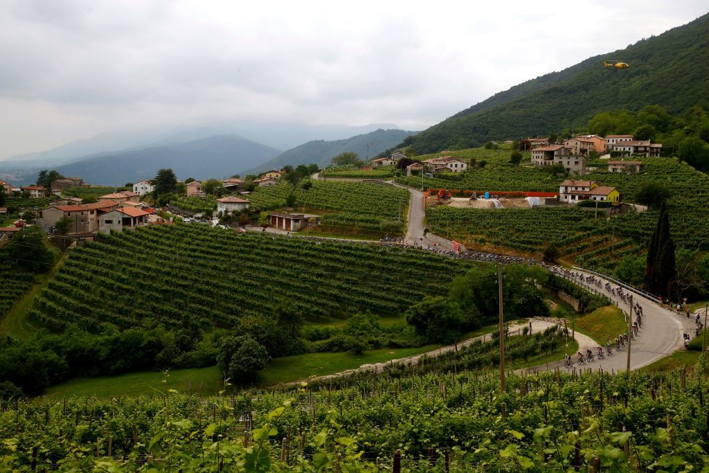 The pack rides near Valdobbiadene during the 18th stage of the Giro dItalia 2022 cycling race 156 km from Borgo Valsugana to Treviso on May 26 2022 Photo by Luca Bettini AFP Photo by LUCA BETTINIAFP via Getty Images