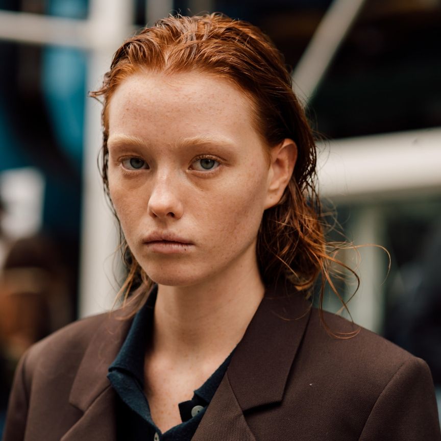 a redheaded woman with pale skin close up