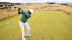 Tiger Woods hits an iron shot in practice for the Open