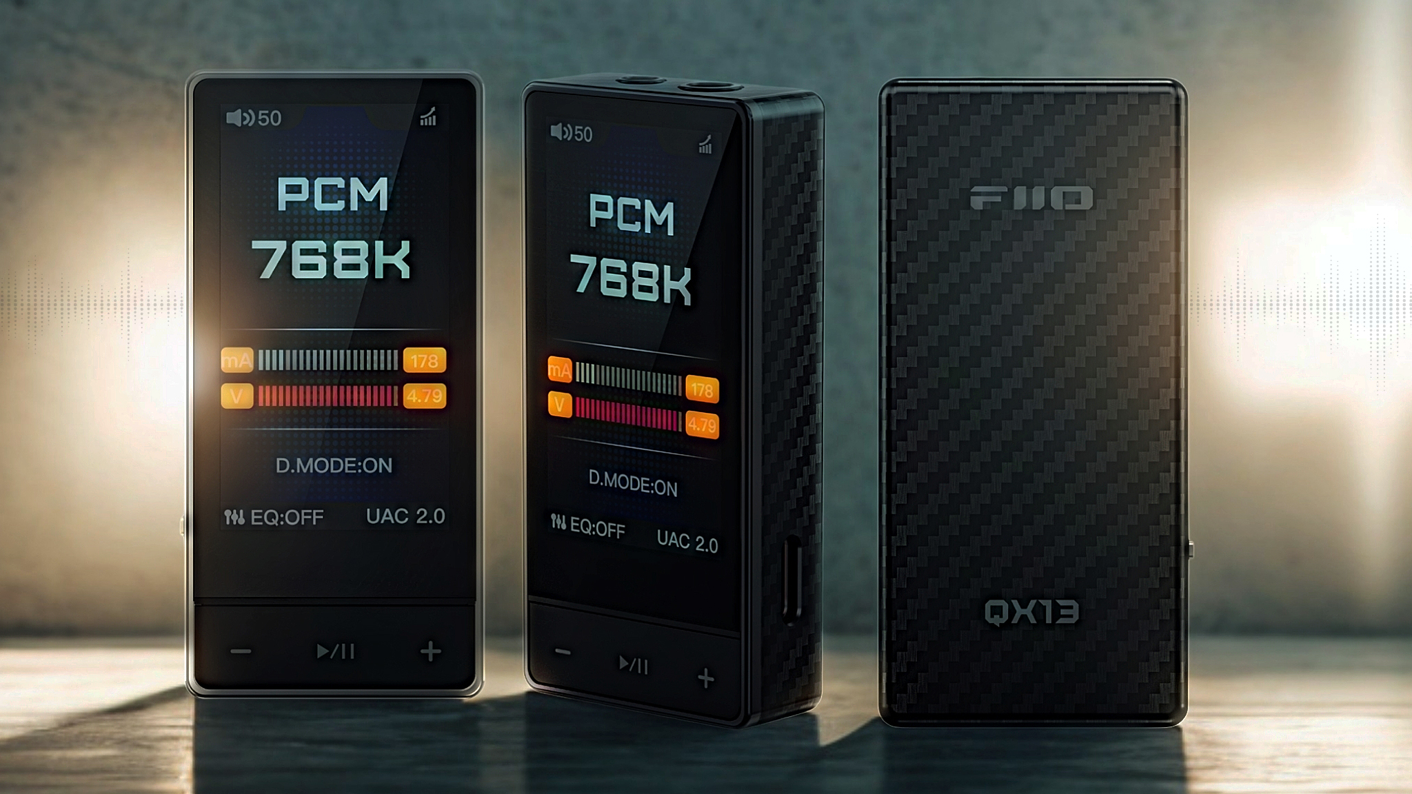 Three FiiO QX13 DACs shot against a brightly lit background