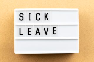 a light box with the words sick leave displayed