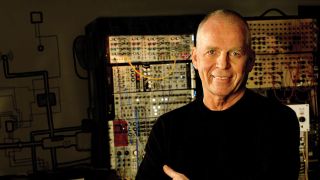 A photograph of Peter Baumann: electro pioneer in front of his equipment
