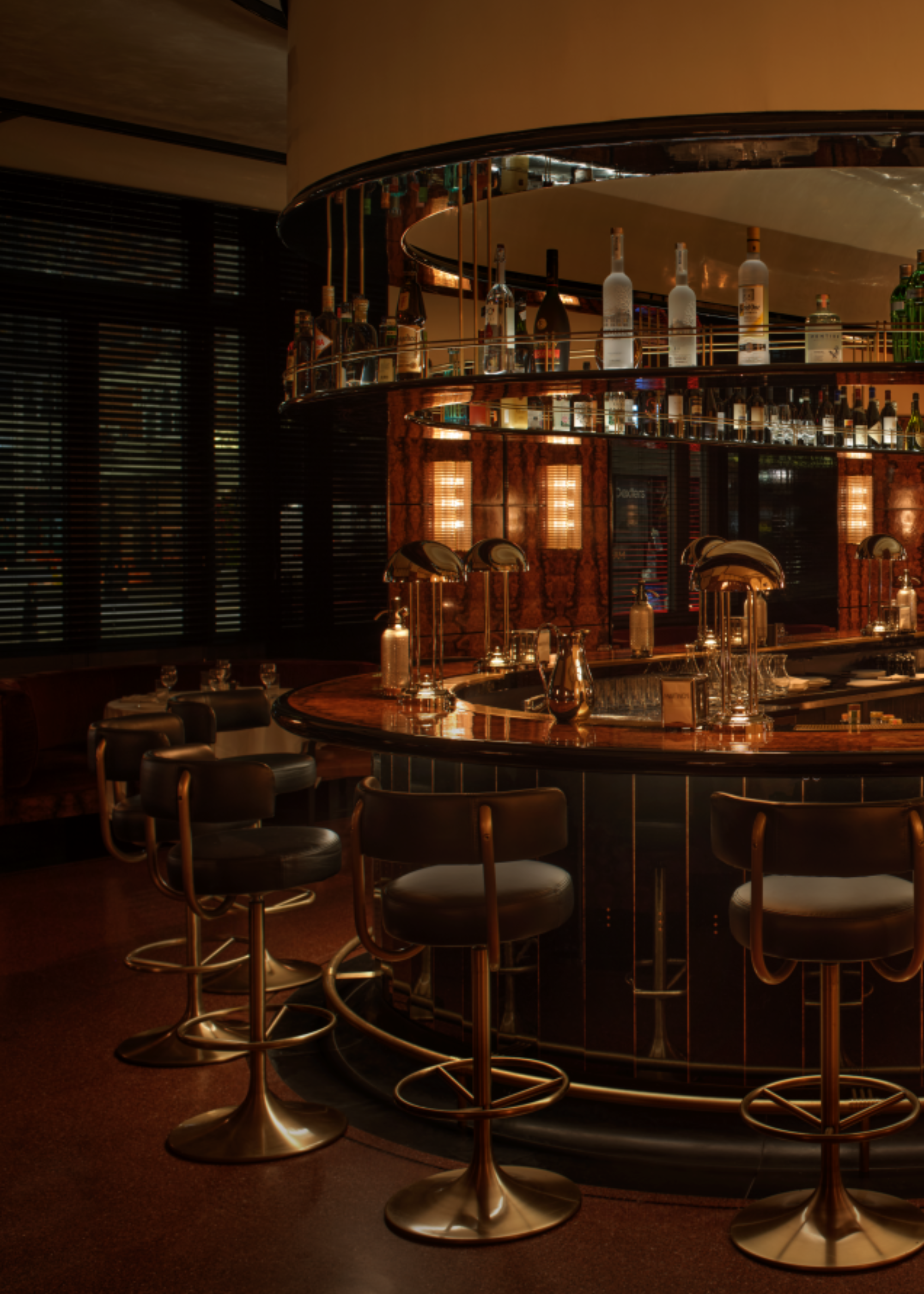 Oval bar in martinos with chrome lamps decorating the surface