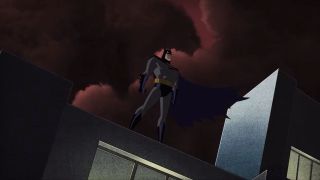 Kevin Conroy's Batman standing on Gotham City rooftop