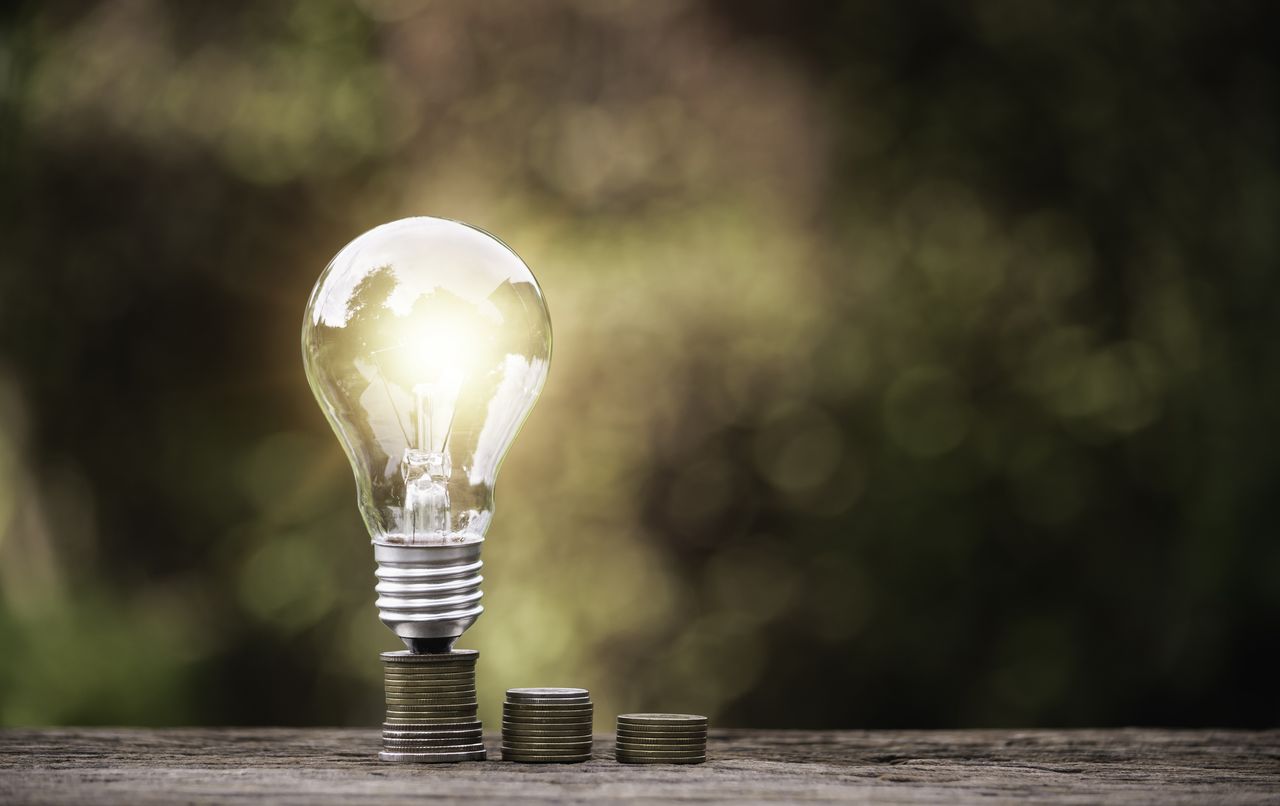 Energy saving light bulb stacks of coins 