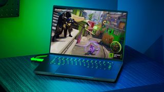 Razer Blade 16 gaming laptop on desk with green lighting