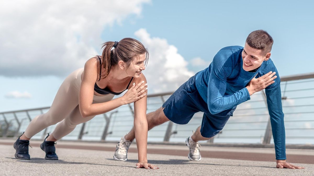 a photo of a man and woman performing plank shoulder taps