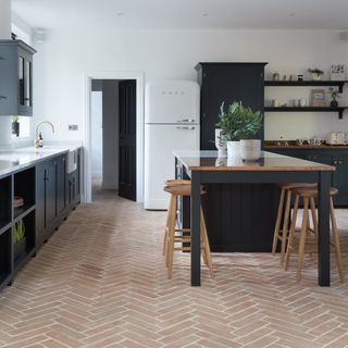 kitchen with floor tiles and dinning table chair