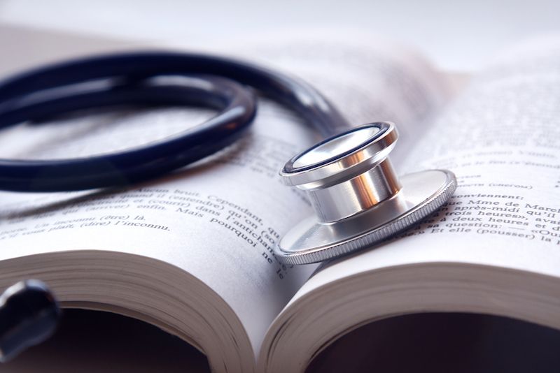 A medical textbook, and a stethoscope