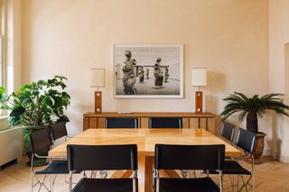 Conference room with wood table and black chairs, green plants and art on the wall at the Prinsengracht venue