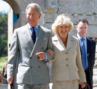 Prince Charles, Prince of Wales and Camilla, Duchess of Cornwall walk arm in arm during a visit to Hugh Town, on the island of St Mary's on May 20, 2005 in Isles of Scilly, England.