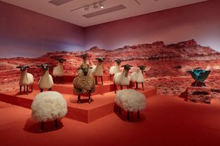 Furry seat pouf and 3D sheep sculptures behind