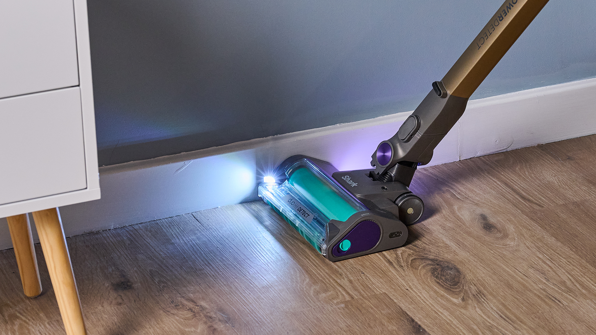 Shark PowerDetect Cordless being used on a wood laminate floor
