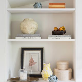 open shelving in a living room with various items on display