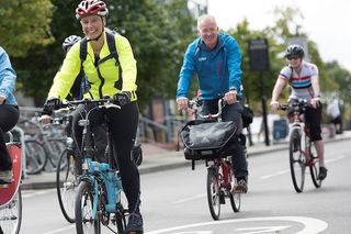 Commuters cycling through London on folding bikes