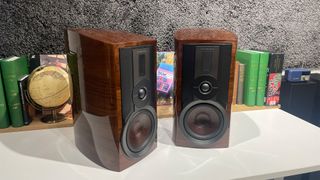 Dali Epikore 3 standmount speakers angled inwards on white shelf