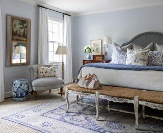 Wicker and wooden bench, white and blue bed and carpet