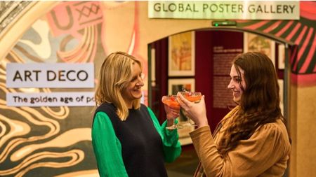 an image of two women cheersing cocktails at the museum as part of their art deco lates