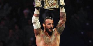 CM Punk holding up the title