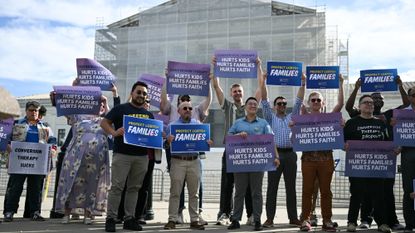 Demonstrators pose for a photo as they protest against conversion therapy outside the US Supreme Court as the Court hears oral arguements in Chiles v. Salazar, a landmark case on conversion therapy, on October 7, 2025, in Washington, DC. The Supreme Court will hear a challenge today by a Christian therapist to a Colorado law that bans "conversion therapy" for minors who are questioning their gender identity or sexual orientation. The case was brought by Kaley Chiles, a licensed mental health counselor who argues that the prohibition from holding such conversations with minors is a violation of her First Amendment free speech rights. (Photo by ANDREW CABALLERO-REYNOLDS / AFP) (Photo by ANDREW CABALLERO-REYNOLDS/AFP via Getty Images)
