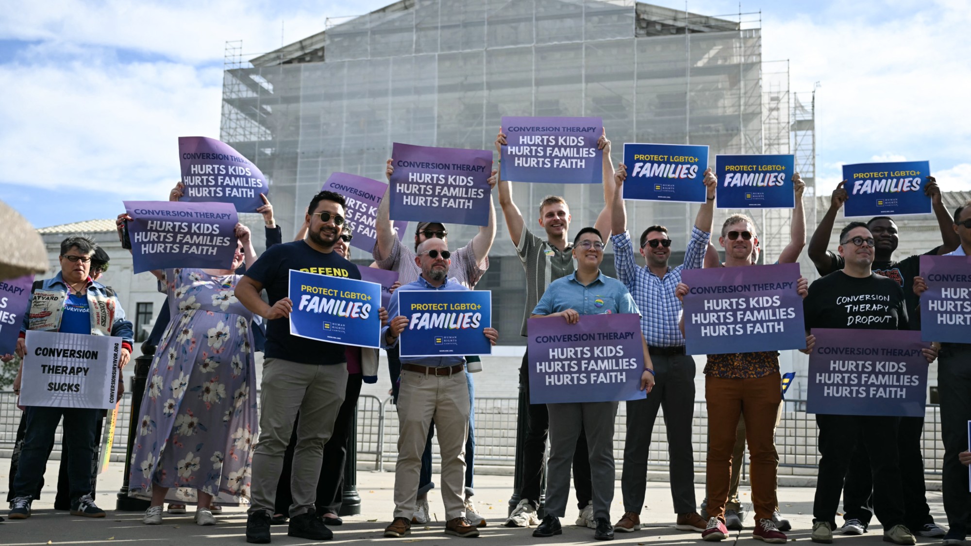 Demonstrators pose for a photo as they protest against conversion therapy outside the US Supreme Court as the Court hears oral arguements in Chiles v. Salazar, a landmark case on conversion therapy, on October 7, 2025, in Washington, DC. The Supreme Court will hear a challenge today by a Christian therapist to a Colorado law that bans "conversion therapy" for minors who are questioning their gender identity or sexual orientation. The case was brought by Kaley Chiles, a licensed mental health counselor who argues that the prohibition from holding such conversations with minors is a violation of her First Amendment free speech rights. (Photo by ANDREW CABALLERO-REYNOLDS / AFP) (Photo by ANDREW CABALLERO-REYNOLDS/AFP via Getty Images)
