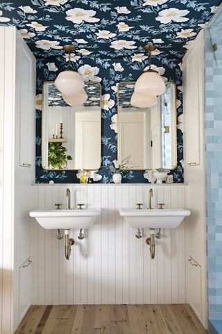 small bathroon with floral wallpaper on walls and ceiling