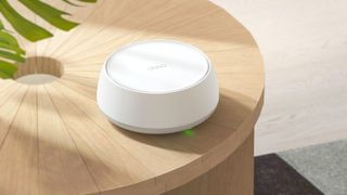 TP-Link Deco BE23 mesh router on a side table