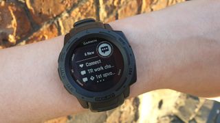 Woman's wrist with Garmin Instinct Solar showing app notifications