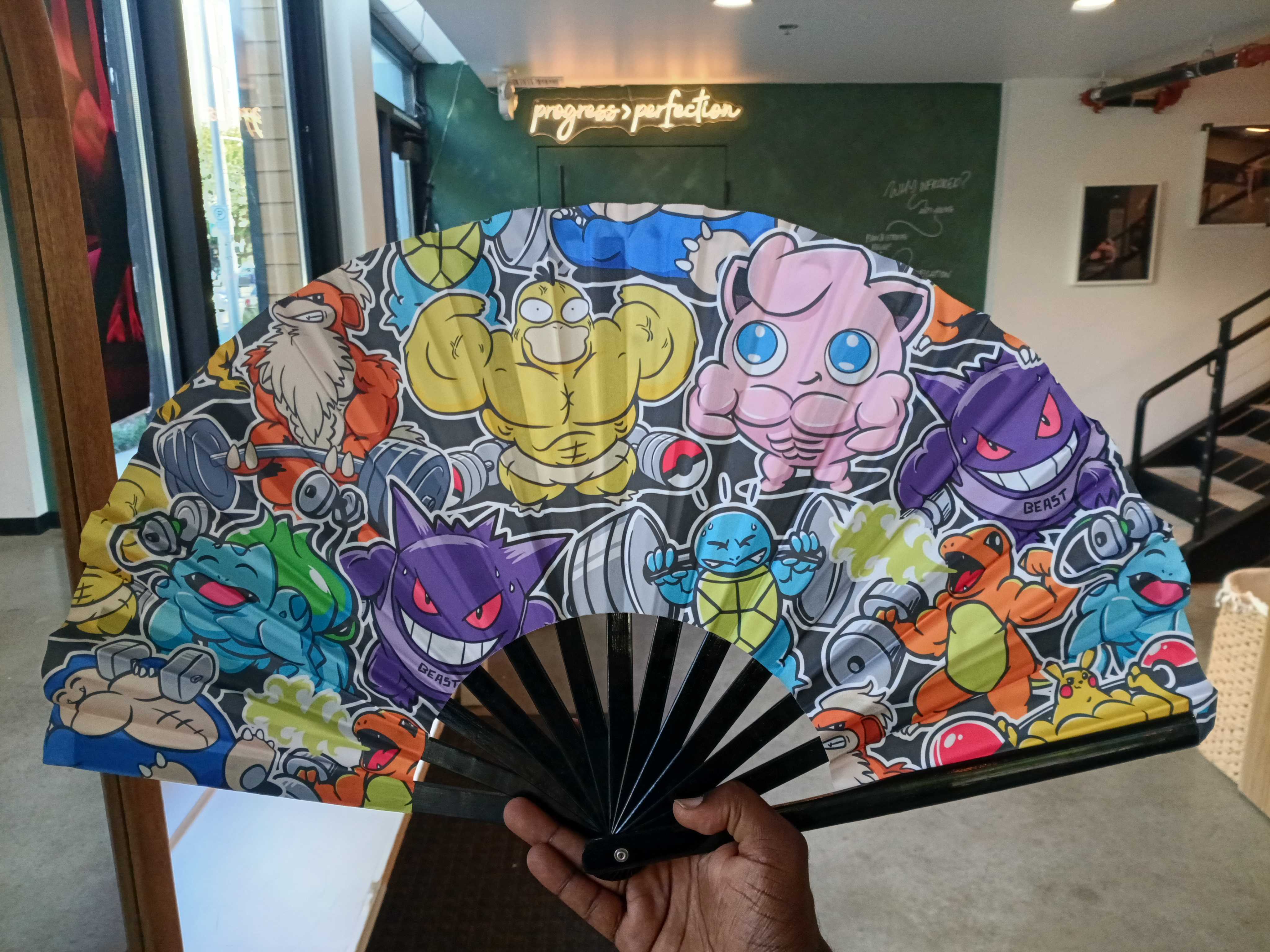 A colorful fan with muscular Pokémon 