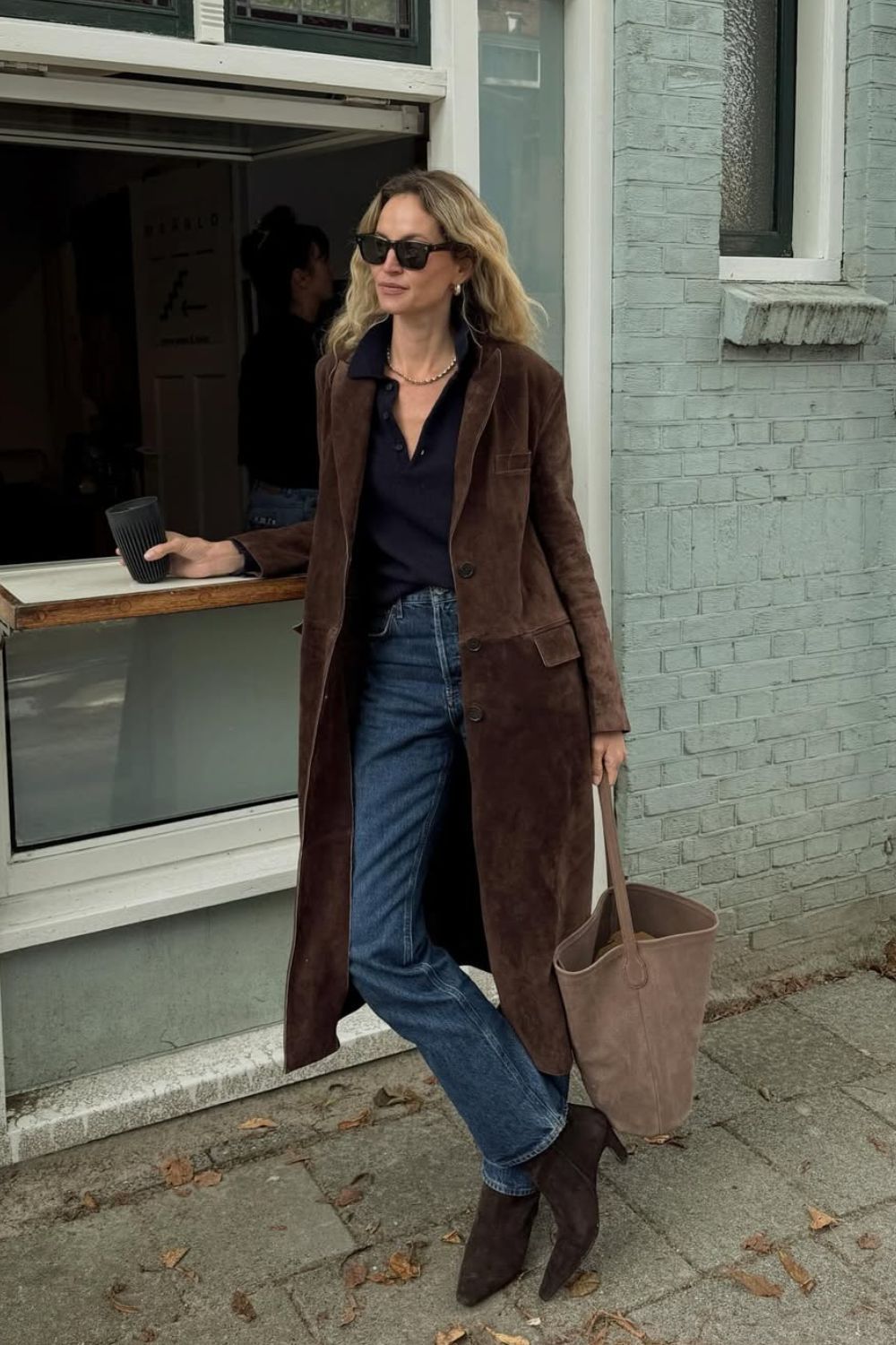 Anti-flat shoes trends winter 2025 @anoukyve wearing suede coat, blue jeans and brown suede ankle boots