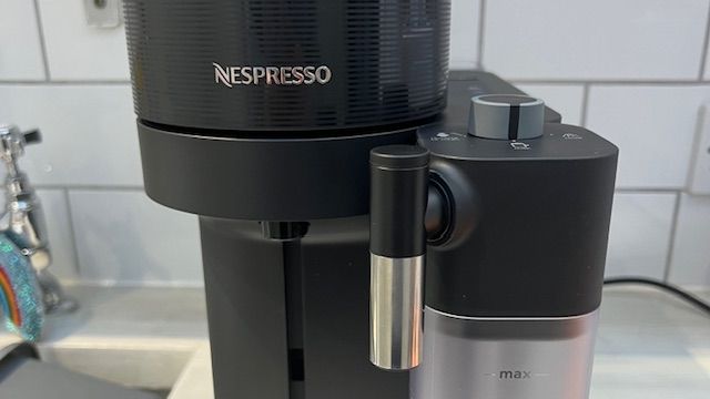 Image showing the top of the machine, including the spout from the milk carafe and setting dial on top