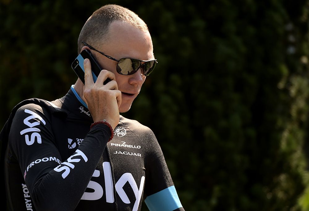 Team Sky's Chris Froome on the phone after team training session in Utrecht