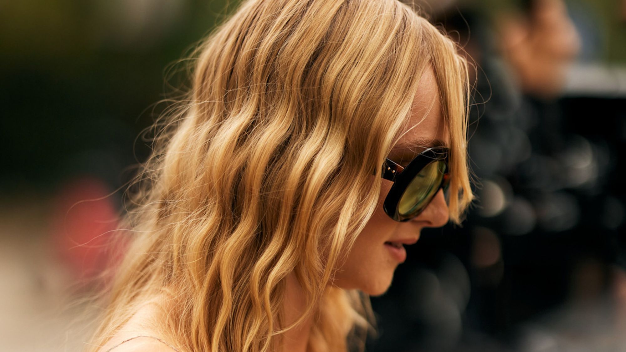 street style shot of blonde woman with wavy hair