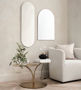 living room with white sofa and mirror on white wall