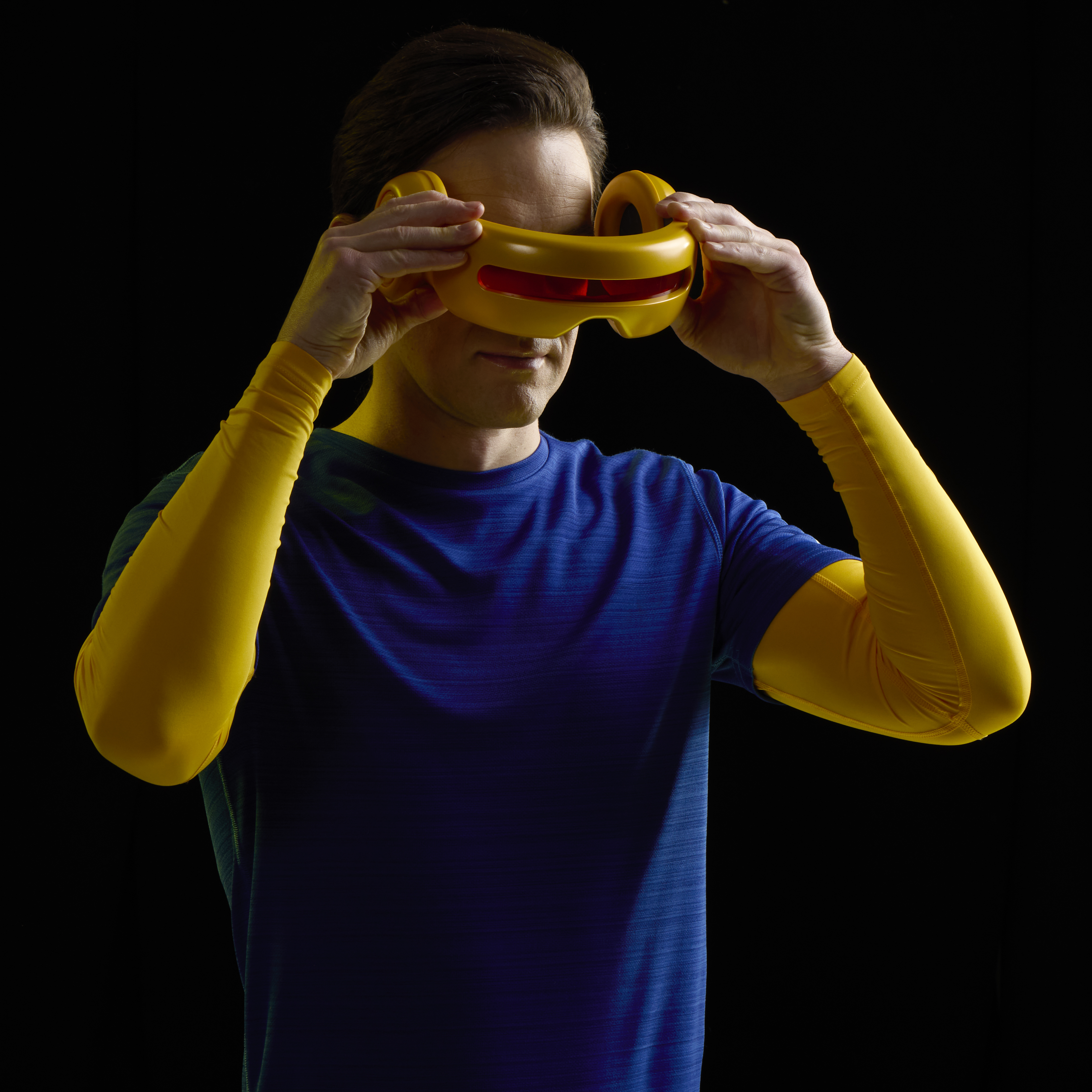 A man holds the Cyclops Premium Roleplay Visor up in a dark room