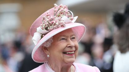 Queen Elizabeth II meets guests as she attends the Royal Garden Party at Buckingham Palace on May 29, 2019 in London, England.