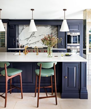Modern kitchen diner with blue cabinets and bar stools