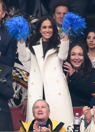 Meghan Markle in a white coat