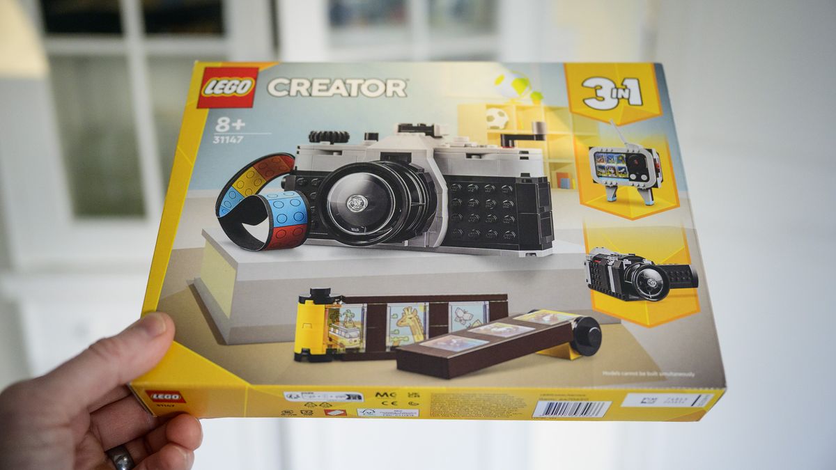 Lego Retro Camera 3 in 1 set in its box, held by user