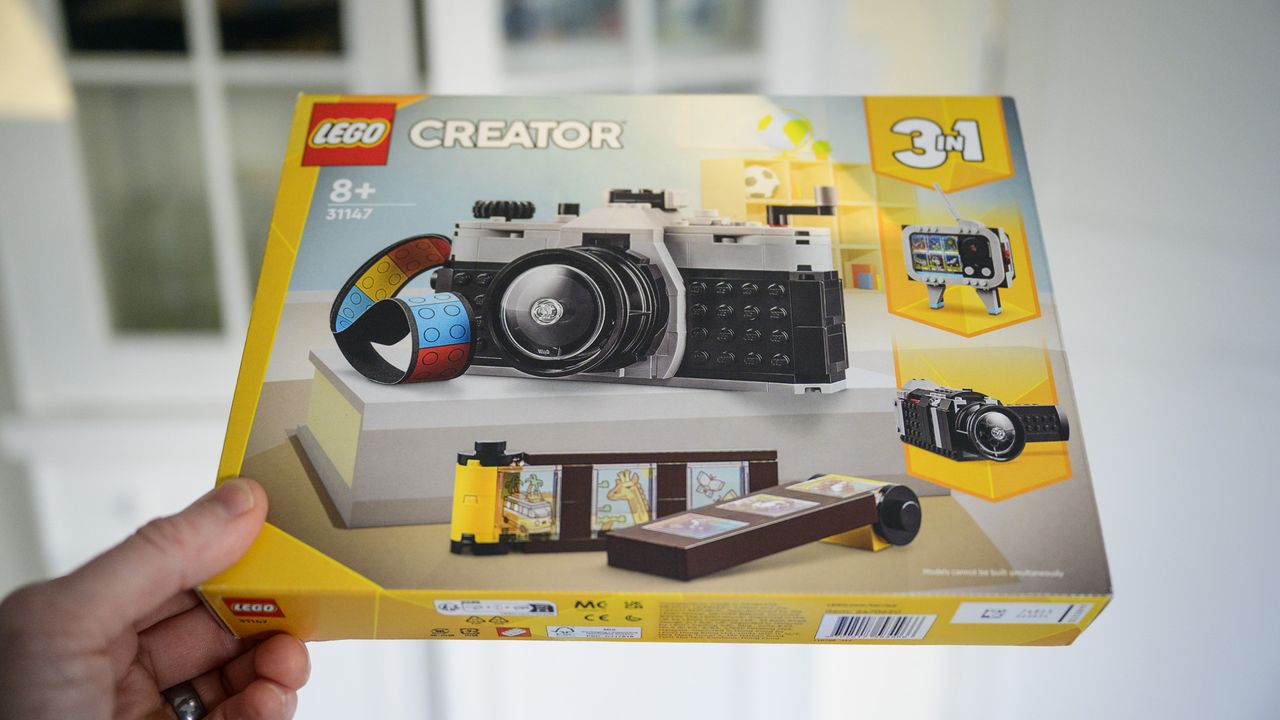 Lego Retro Camera 3 in 1 set in its box, held by user