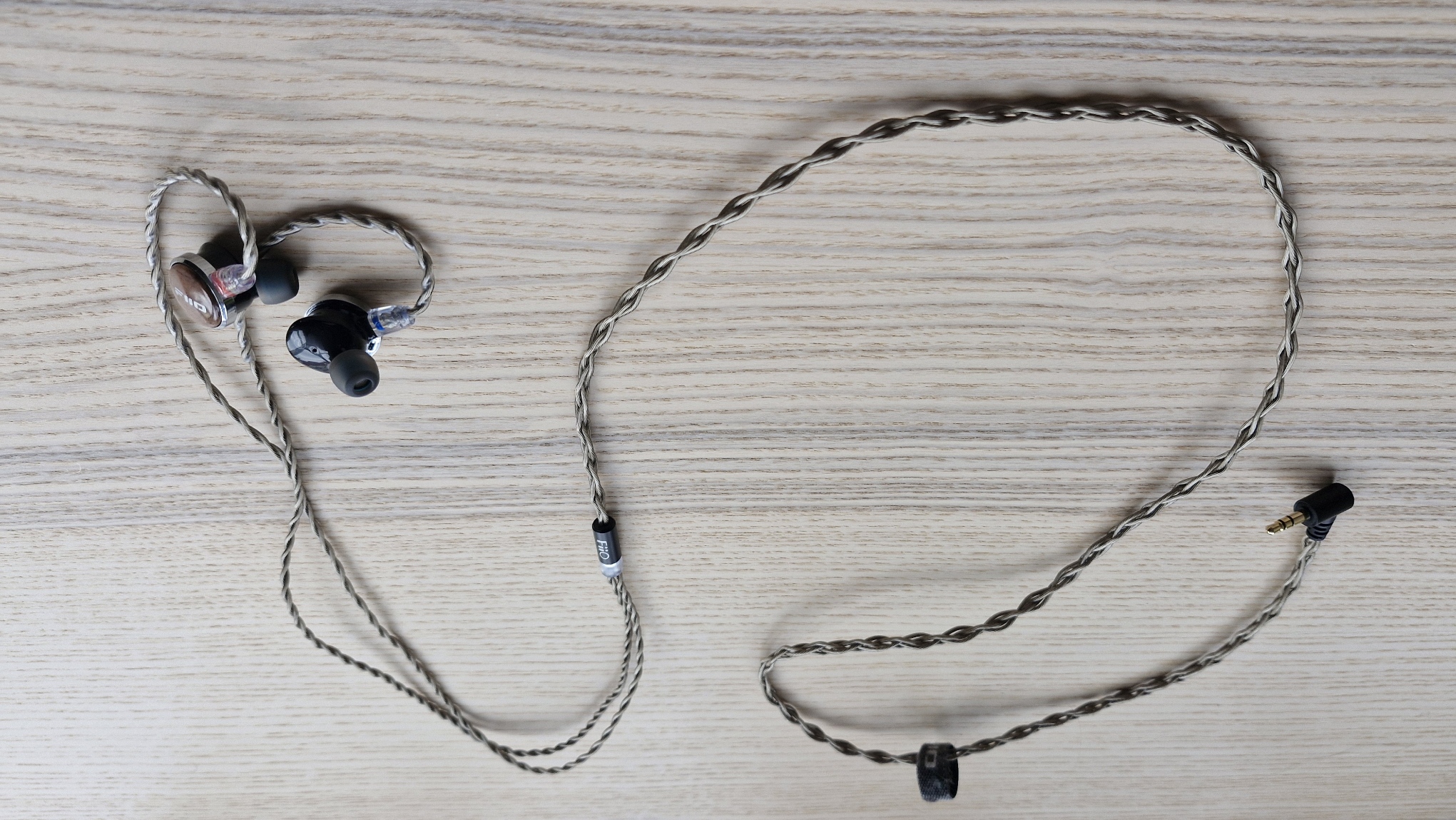 FIIO FP3 wired earplugs on wooden surface