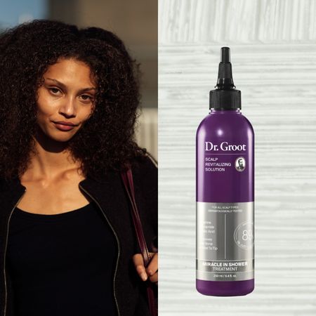 a woman with dark curly hair in a black jacket next to a gray background with a purple bottle of Korean hair care