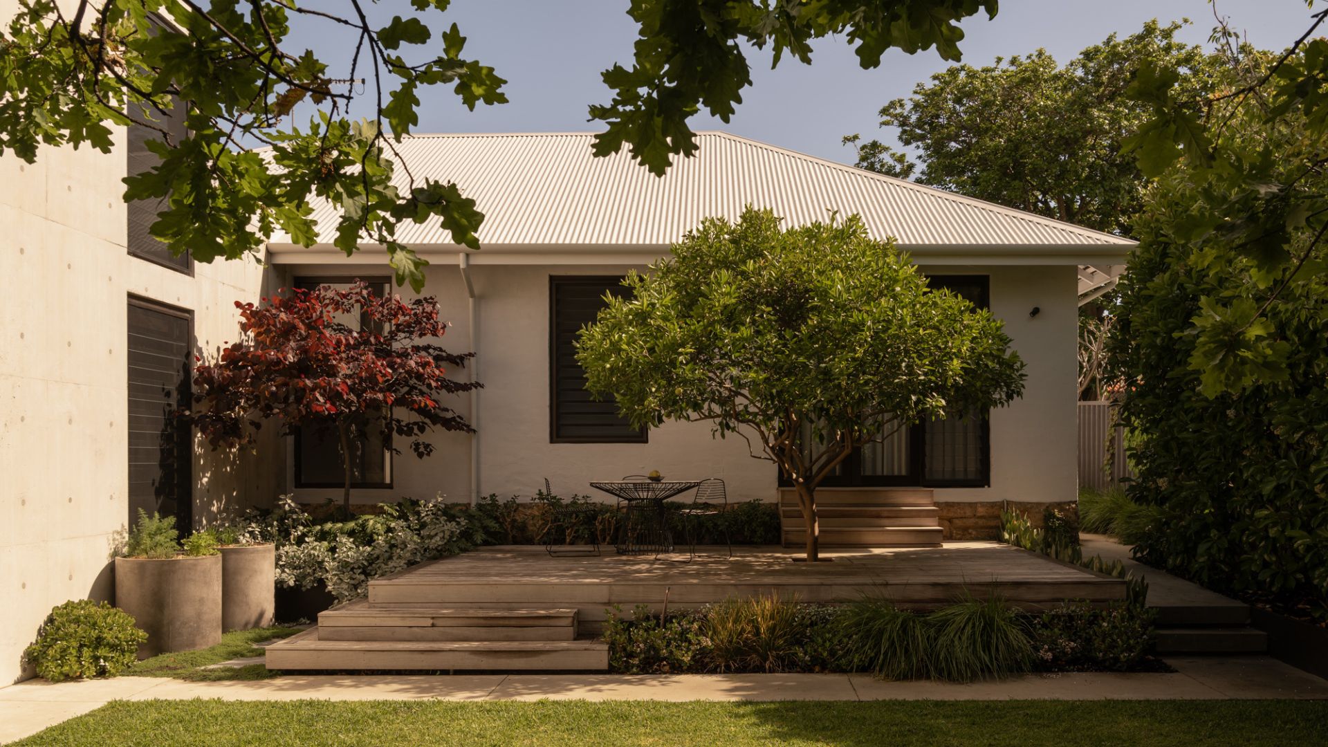 A spacious outdoor garden with potted plants and trees