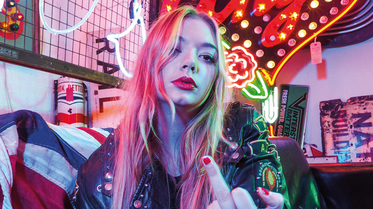 A press shot of Becca from Marmozets giving the finger