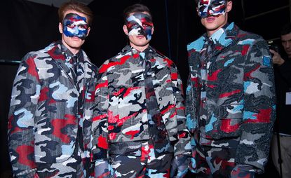 Models wearing grey, red and blue camo outfits
