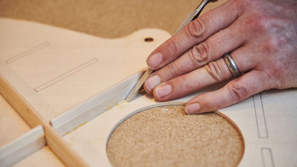 Guitar luthier adjusting bracing