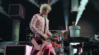 Machine Gun Kelly onstage with his signature Schecter PT guitar