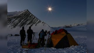Chilean and U.S. scientists look at the total solar eclipse from the Union Glacier in Antarctica on Dec. 4, 2021.