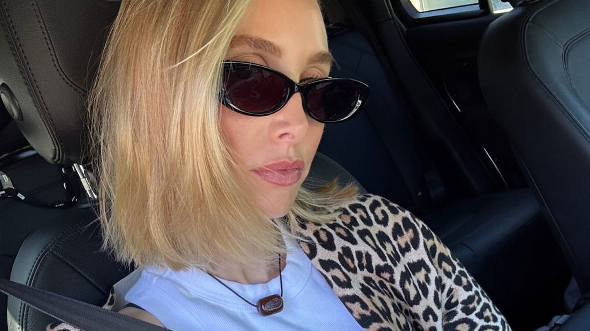 Whitney Port in a leopard sweater and sunglasses.